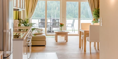 Monteurwohnung - Küche: eigene Küche - Versbichl - Blick ins Wohnzimmer und Terrasse von Bungalow Mountain View Wood  - Ferienwohnung Mountain View 1