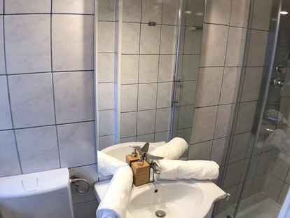 Monteurwohnung - Kühlschrank - Nestelbach bei Graz - Helles Badezimmer mit Dusche der Monteurwohnung in Graz. - Monteurzimmer/Monteurwohnung in Graz