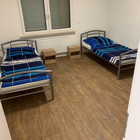 Monteurzimmer: Schlafzimmer mit Einzelbetten der Monteurunterkunft in Worms - Haus Gamster