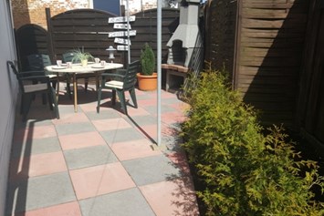 Monteurzimmer: Terrasse mit Gartenmöbeln und Grillkamin - "Haus am Mühlenweg"