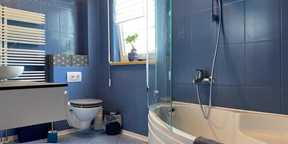 Monteurwohnung - PLZ 04109 (Deutschland) - Badezimmer Obergeschoss mit Badewanne und Duschhalterung mit Glasspritzschutz, Toilette und Waschtisch - Kerstin Schilling