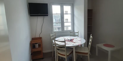 Monteurwohnung - Darmstadt - Wohnzimmer mit Schlafcouch und Schrank. - J&P Brunetti Zimmervermietung Rüsselsheim
