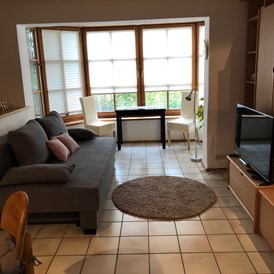 Monteurzimmer: Wohnbereich mit Erker und Sitzgelegenheit - Ferienwohnung Am Spenderberg