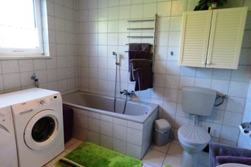 Monteurzimmer: Badezimmer mit DU, Wanne, WC, Waschmaschine und Wäschetrockner - Ferienwohnung Kutscherhuus für Monteure
