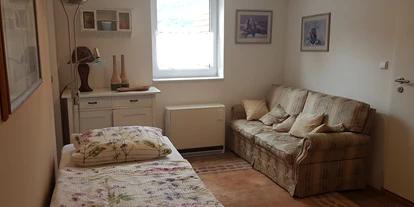 Monteurwohnung - Muggensturm Gaggenau - Zimmer 1 mit Sitzsofa und Kommode - Peter Monteurzimmer Krassa