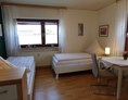 Monteurzimmer: Schlafzimmer mit 2 Einzelbetten und kleiner Sitzgruppe - Karin Stoltenhoff
