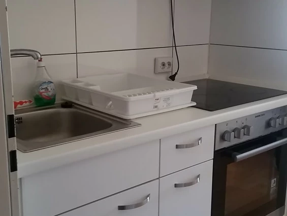 Monteurwohnung: linke Seite der Einbauküche mit Herd und Backofen - Monteurwohnung Rastatt