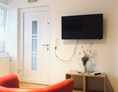Monteurzimmer: Heller freundlicher TV - Wohnbereich mit Ein - Ausgang der Wohnung - Schlafen wie Zuhause Monteur und Ferienwohnungen Rahden