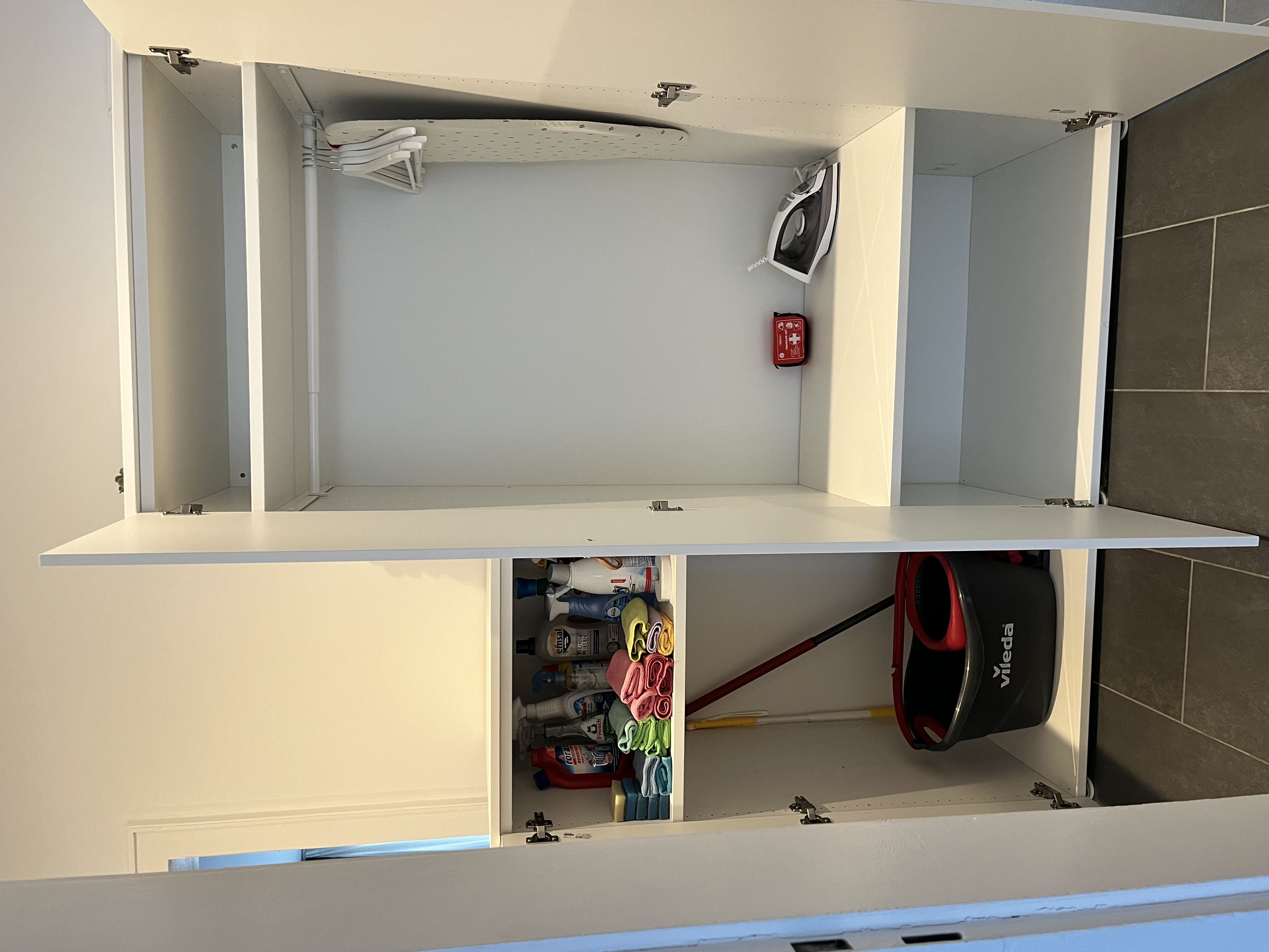 Monteurzimmer: Reinigungsgeräte und Reinigungsmittel Bügeleisen Bügelbrett Kleiderbügel Erste Hilfe Set - 3-Zimmerwohnung Goldstadt Apartments