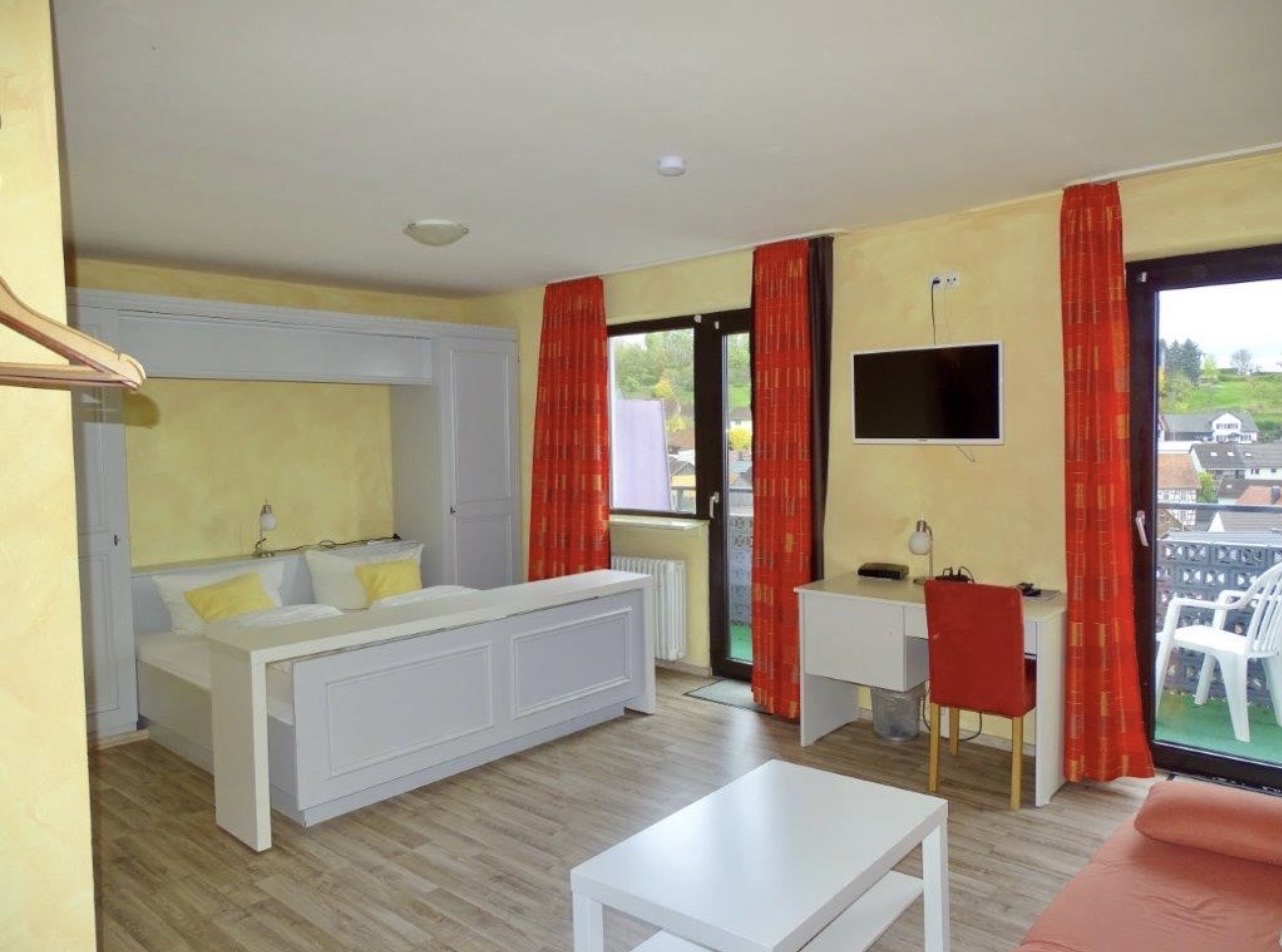 Monteurzimmer: Helles und gemütliches Zimmer mit Doppelbett, Fernseher, Schreibtisch und Zugang zum Balkon - Günstiges Landhaus – ideal für Monteure und Handwerker