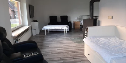 Monteurwohnung - Kaffeemaschine - Schleswig-Holstein - Wohnzimmer mit Kaminofen. - Konrad Adenauer Ring